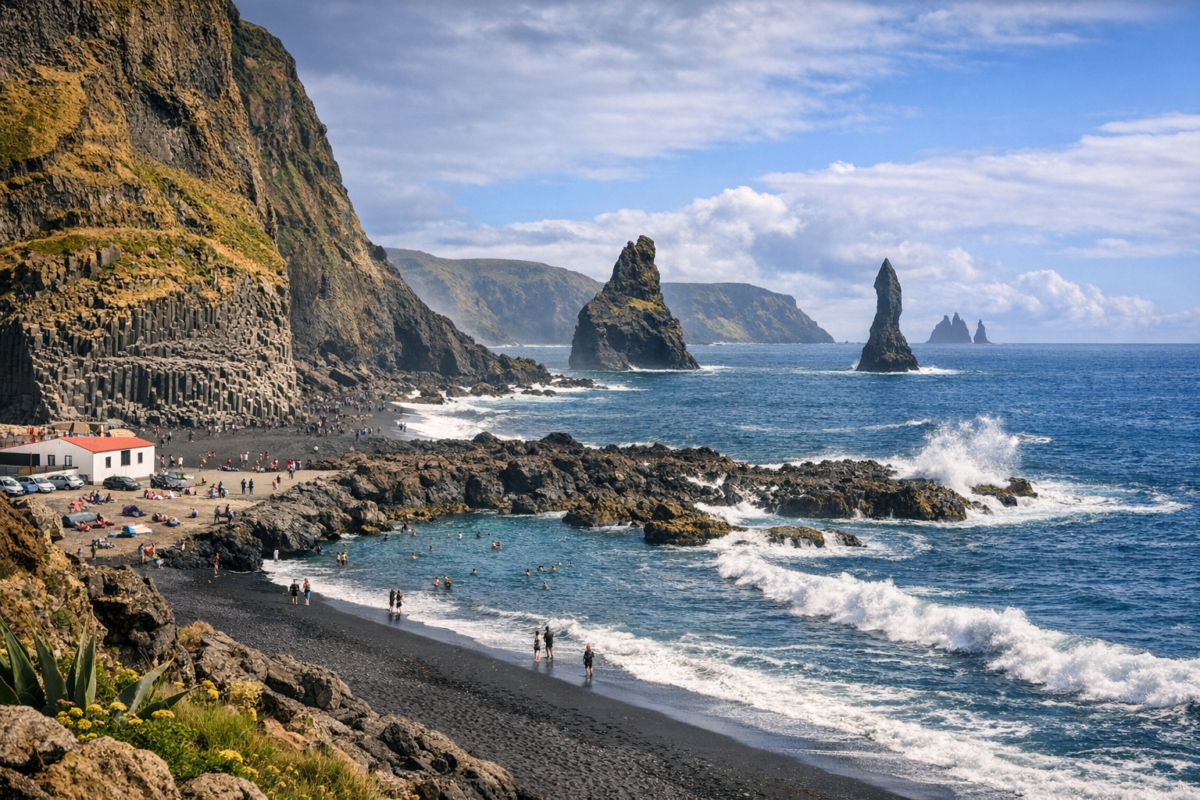 Black volcanic sand, basalt columns, and sea stacks at Reynisfjara Beach on Iceland’s South Coast.